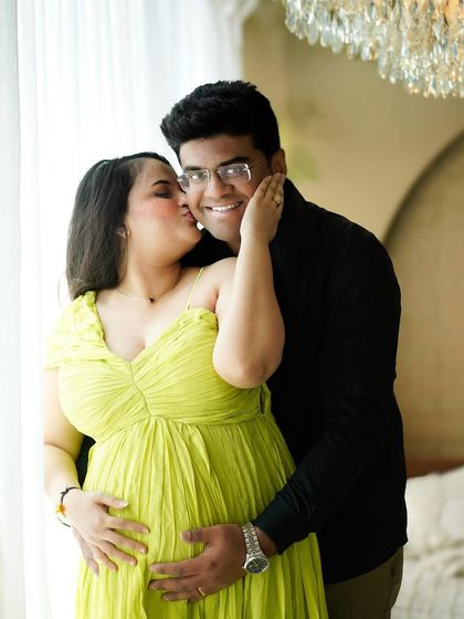 A sweet kiss and a happy smile. We love capturing these candid, joyful interactions that show the real love story behind the bump.