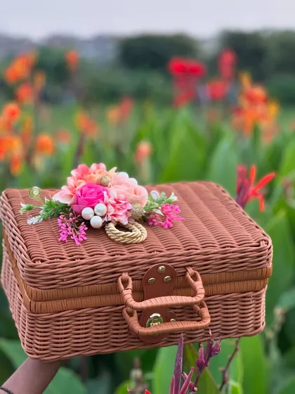 Our rattan style suitcases are a perfect blend of style and function. Here, I’ve decorated a classic brown suitcase with a beautiful floral arrangement, turning a simple box into a bespoke gift hamper ready to be filled with love.