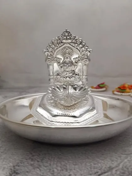 A slightly different angle of the Lakshmi diya on a plate, showing its compact and elegant design.