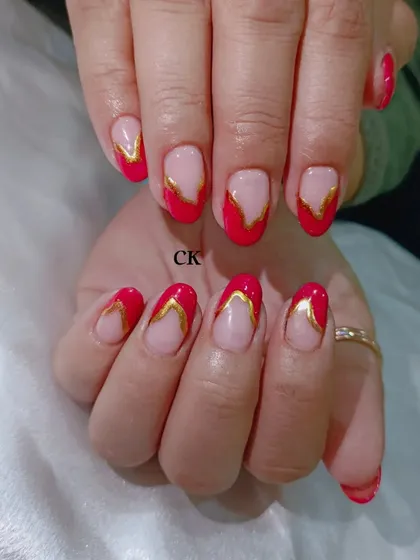 A bold and striking design featuring a red French tip with a unique V-shape, outlined in gold chrome for extra definition.