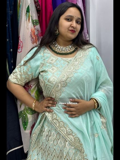 A confident pose from a happy client, showcasing the beautiful neckline of the blouse and the matching choker.