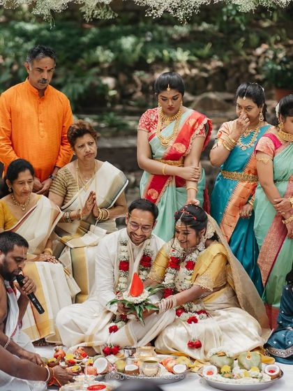 A family gathers around the couple during an intimate wedding ritual, showcasing the importance of community and blessings.