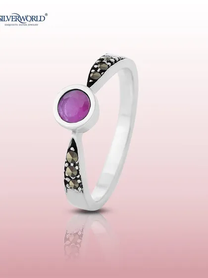 Similar to the emerald version, this ring showcases a vibrant ruby as its centerpiece, complemented by the subtle sparkle of marcasite stones on the band.