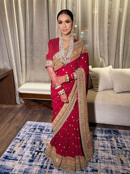 This full-length portrait shows how the sleek hairstyle and dramatic makeup come together to create a sophisticated and cohesive bridal statement.