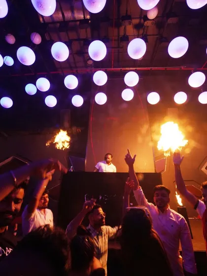 The crowd goes wild as pyro effects go off in front of the DJ booth. I love incorporating spectacular elements like this to create a memorable show.