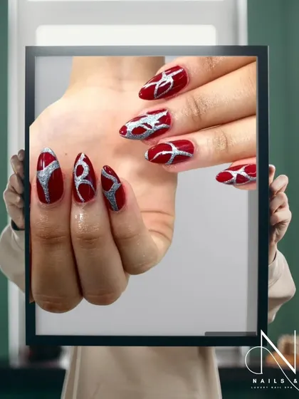 A fiery abstract design. We used a deep red base and added a tribal-inspired pattern in sparkling silver for a powerful and eye-catching look.