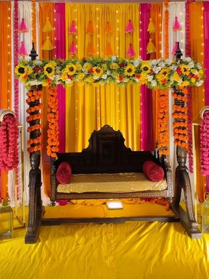 A decorated jhoola (swing) is a must-have for any Mehandi or Haldi. We adorn a traditional wooden swing with bright floral arrangements and colourful drapes to create a beautiful and fun seating area for the bride.