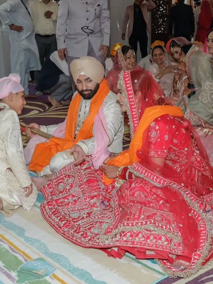 A touching moment as a young family member participates in the Anand Karaj ceremony. Capturing these intergenerational interactions is a key part of my storytelling.