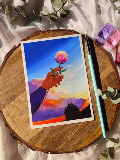A surreal and dreamy painting of a hand holding a rose that is also the moon, set against a sunset sky. A bit of moon therapy.
