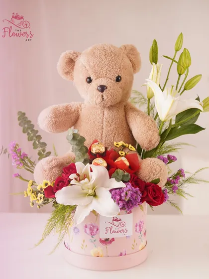 My popular teddy bear gift hamper combines a beautiful arrangement of white lilies and red roses with Ferrero Rocher chocolates and a cuddly teddy bear. It's an all-in-one gift designed to deliver joy and affection.