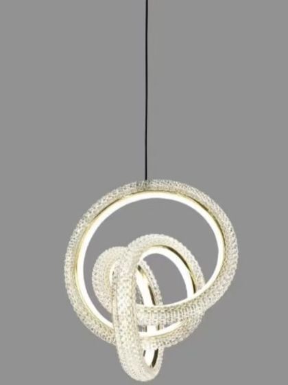 A modern LED pendant with intertwined, crystal-encrusted rings. This compact and stylish light is perfect for a small dining nook or as a cluster in a larger space.