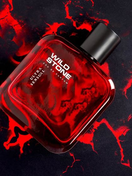 A dramatic and fiery visual for Wild Stone's Ultra Sensual perfume. The red and black abstract background evokes a sense of passion and intensity, perfectly matching the product's name and target audience.