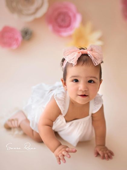 A beautiful shot of a mommy and her mini from the archives. The paper flower backdrop and her gorgeous dress created such a stunning, high-fashion look.