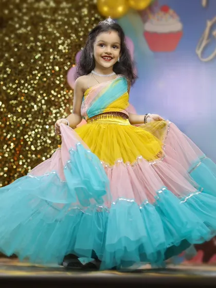 The birthday girl shines in her colorful party dress. Our kids' portrait sessions are all about capturing their personality, and we make sure to get beautiful, happy shots like this one amidst the celebration.