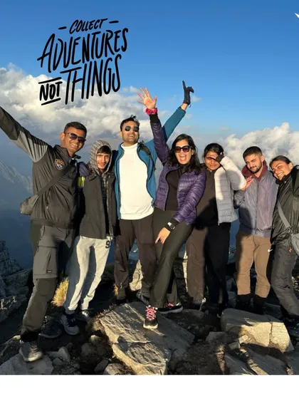 Collect adventures, not things. A happy group celebrating their achievement at the summit.