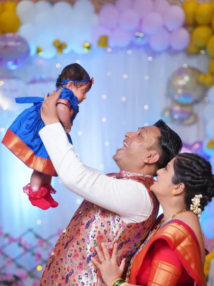 A joyous moment between parents and their newborn at her naming ceremony. I focus on capturing the love and happiness of the family during these important cultural events.