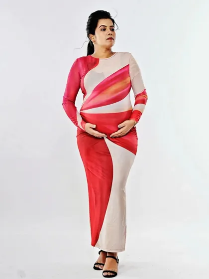 A full-length shot of the mother-to-be, looking serene and beautiful. The simple makeup and hair allow the focus to be on her and the beautiful journey she is on.