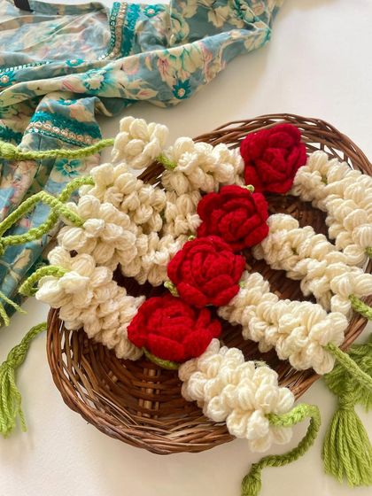 A beautiful, flat-lay of the crochet gajra in a wicker basket, ready to be shipped to a client.