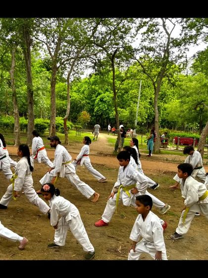 A dynamic shot of the kids practicing their stances and lunges together. Training as a group outdoors builds a powerful sense of unity.