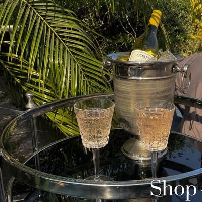 A close-up of our bar trolley, showing an ice bucket and crystal-cut glasses ready for serving. It’s all about having your bar essentials organized and accessible.