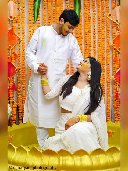 The Haldi ceremony is all about vibrant color and pure happiness. I captured this couple sharing a loving look amidst the celebration, coordinating in white outfits that made the yellow turmeric pop. It's a perfect example of candid wedding photography.