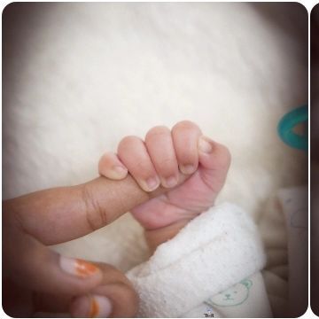 A newborn's hand wrapped around a parent's finger. This simple shot speaks volumes about connection and love.