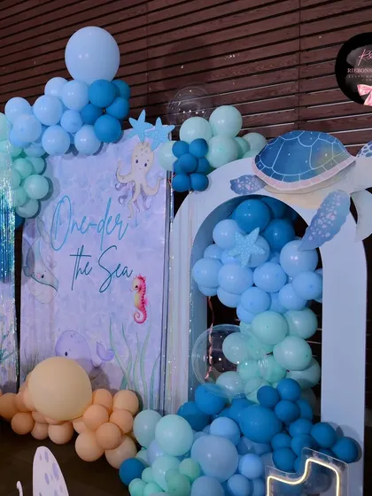 This shot highlights the turtle cutout and the balloon "bubbles" flowing out of the archway, adding to the underwater effect.