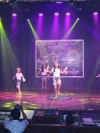 The full group of our hula hoop performers, dancing with joy and energy at the annual show.