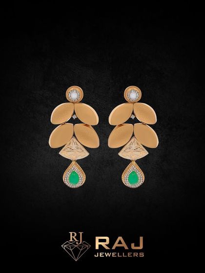 These nature-inspired earrings feature golden leaves cascading down to a vibrant green teardrop stone. They are a perfect accessory for adding a touch of organic elegance to your look.