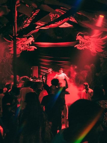 The crowd at Hilltop, with its iconic dragon decor, bathed in red light. Playing at legendary venues like this is always a special experience.