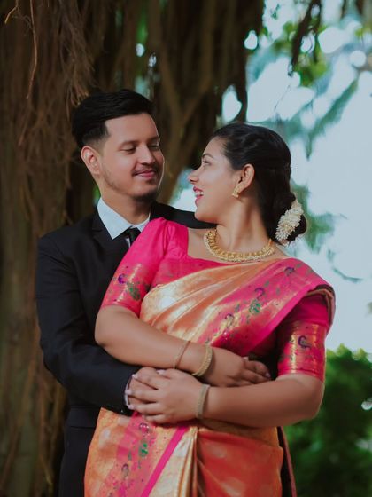 The way they look at each other speaks volumes. A classic, romantic pose that is always beautiful, especially in a lovely outdoor garden.