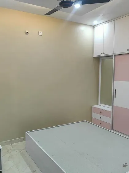 The bedroom for a younger family member, featuring a custom bed, study unit, and wardrobe, all designed to create a cohesive and functional space.