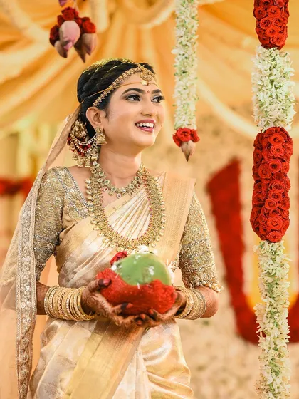 A classic bridal pose. Rakshita looks serene and stunning, holding the traditional coconut as part of the ceremony.
