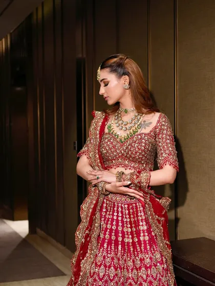A candid moment showing the flow and silhouette of the red lehenga. My goal is to ensure you not only look beautiful but feel completely yourself.