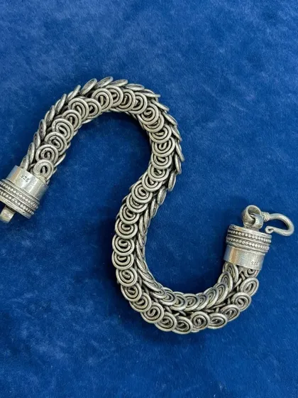 Our unisex chainmail-style bracelet, shown unclasped to highlight its flexible design and sturdy clasp. The oxidized finish gives it a bold, impactful look.