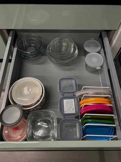 A drawer for glass bowls and storage containers. We've used a vertical file for the lids, which is our go-to trick for keeping them under control.
