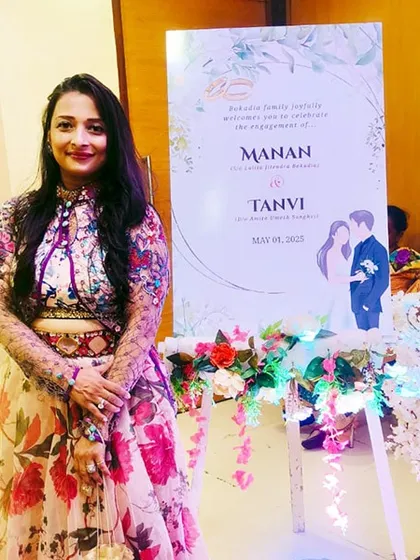 Posing by the welcome sign for Manan and Tanvi's engagement in Sanchore. As an event host, I ensure every detail, from the decor to the event flow, warmly welcomes your guests.