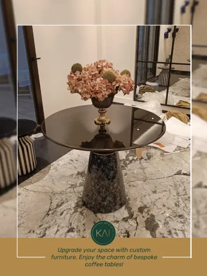 A sophisticated accent table with a dark, glossy top and a textured black marble base. This piece is perfect for displaying a floral arrangement or a piece of art, adding a touch of custom-made charm to a room.