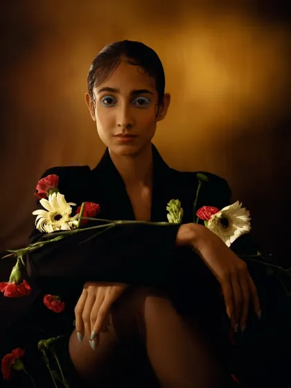 A painterly portrait where the model is adorned with fresh flowers. The lighting is reminiscent of old master paintings, creating a timeless and artistic feel.