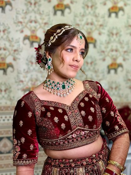 A side profile showing the elegant hairstyle and the flawless finish of the makeup.