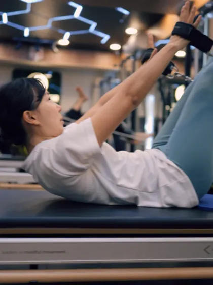 This abdominal curl on the reformer targets the upper abs while using the straps for assistance and resistance, helping to build a stronger, more defined core.