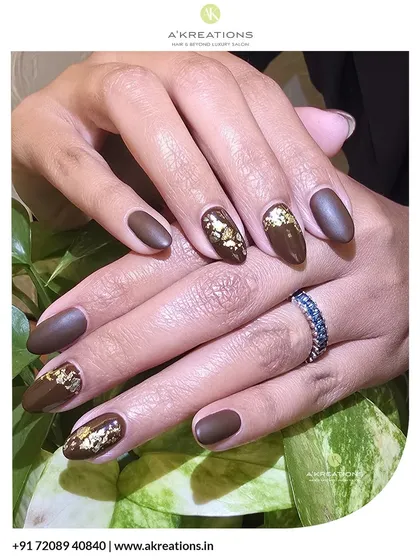 I love combining textures for a sophisticated result. Here, I used a rich, matte brown polish on almond-shaped nails and added delicate gold foil accents to a few nails for a touch of warmth and elegance.