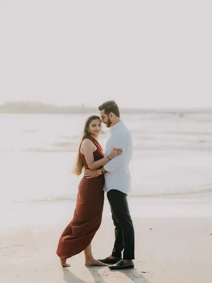 A classic beach portrait. The couple's relaxed pose and the soft light make this a simple yet beautiful image capturing their connection.