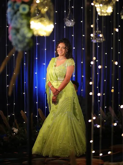 A beautiful portrait against a backdrop of fairy lights. Her Carnival makeup is luminous and eye-catching, perfect for a festive evening celebration.
