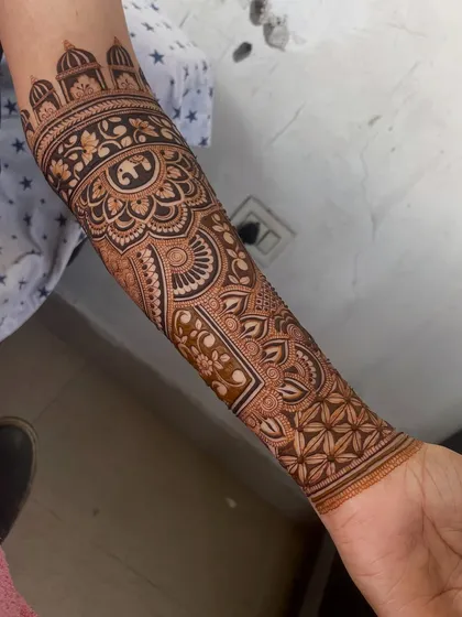 The full view of the arm design, showing how the patterns flow from the wrist to the elbow.