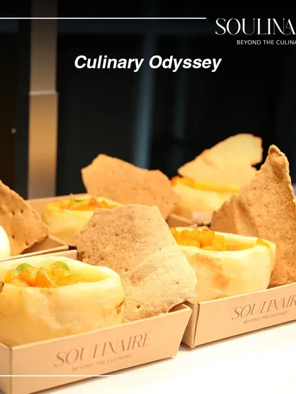 A culinary odyssey in a box. This dish features a creative presentation of a savory dish with crispy crackers, showcasing our innovative approach to catering.