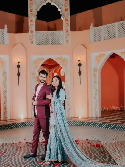 A grand portrait in a stunning courtyard. The bride's flowing traditional outfit and the elegant architecture come together to create a picture of timeless grace.