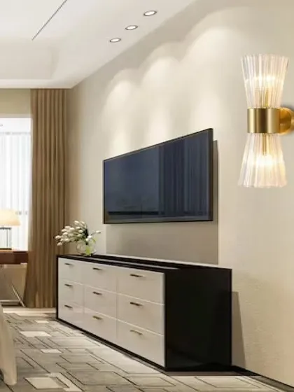The Geneva glass wall lamp features a fluted glass shade that creates a beautiful, diffused light effect. The antique finish and classic design make it an elegant choice for a bedroom or living area.