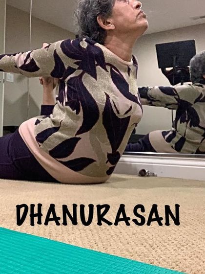 A closer look at Bow Pose, showing the grip on the ankles and the lift of the chest and thighs.