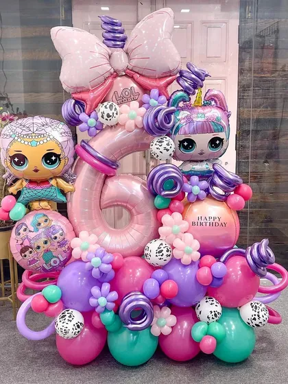 A full, detailed view of the LOL Dolls birthday sculpture. With a giant bow, dalmatian print accents, and two different doll characters, this piece is packed with the fun and surprising elements the brand is known for.